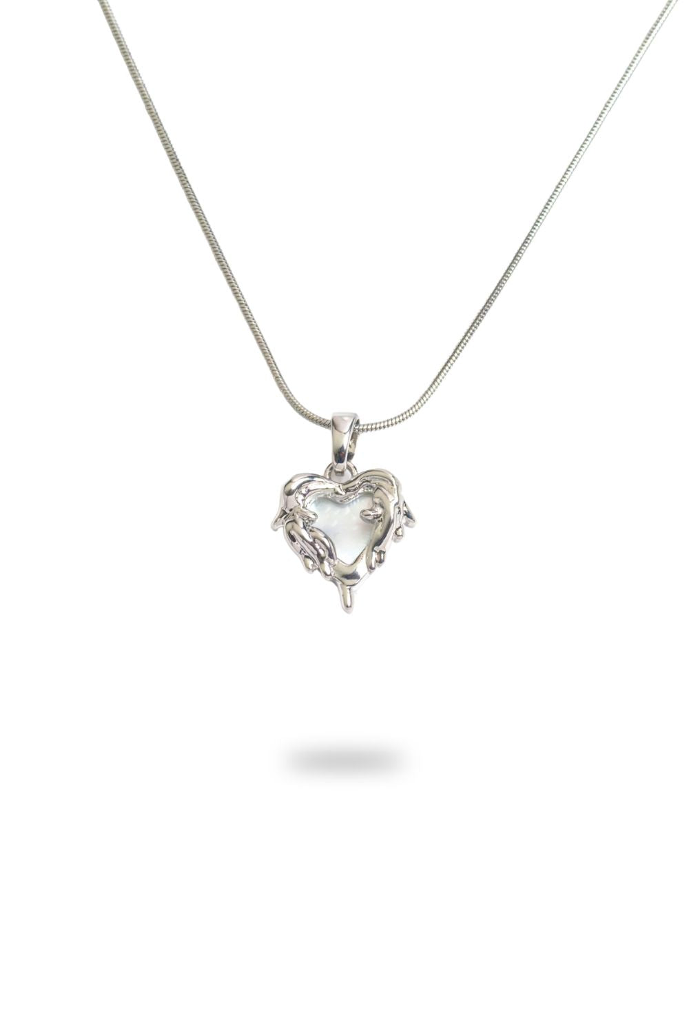 Close-up of mother of pearl heart necklace with gold plated silver