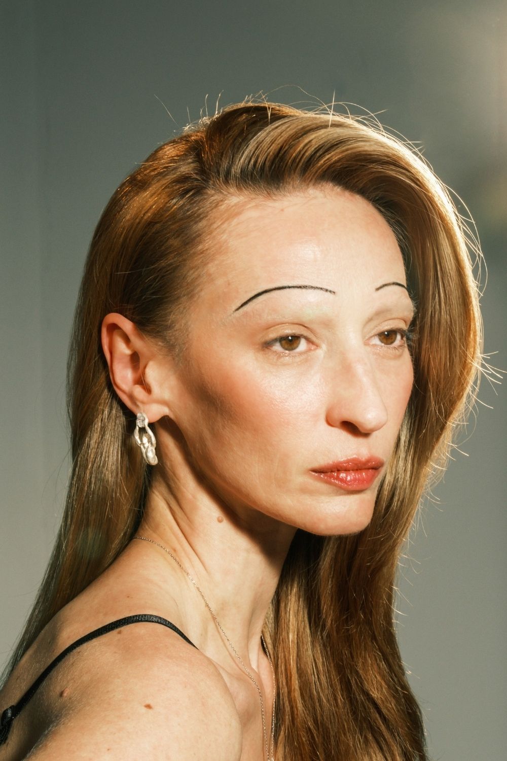 Woman wearing Atlas Earrings inspired by cosmic symbolism