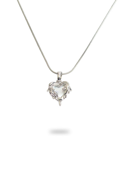 Close-up of mother of pearl heart necklace with gold plated silver