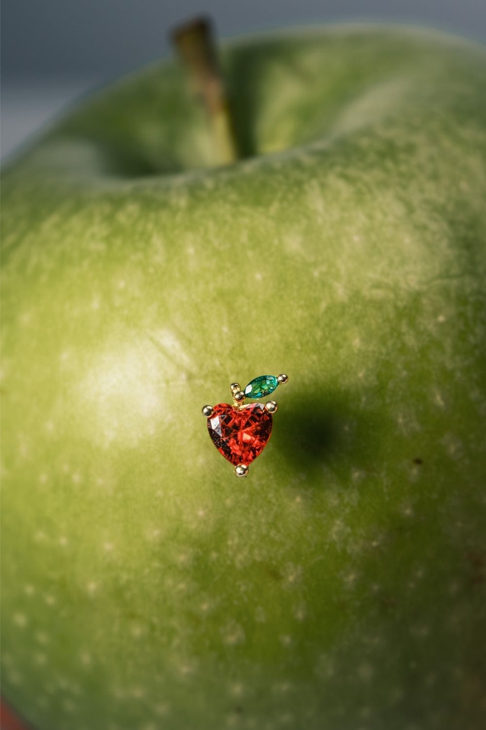 Close-up of Red Apple Baby Earrings with gemstone details