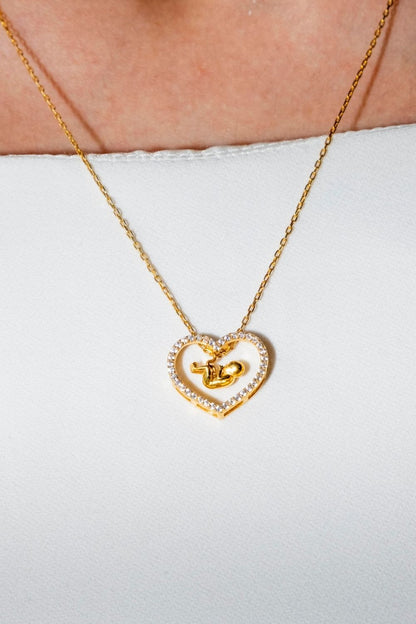 Mother wearing the Ultra Baby Necklace by Piayuli